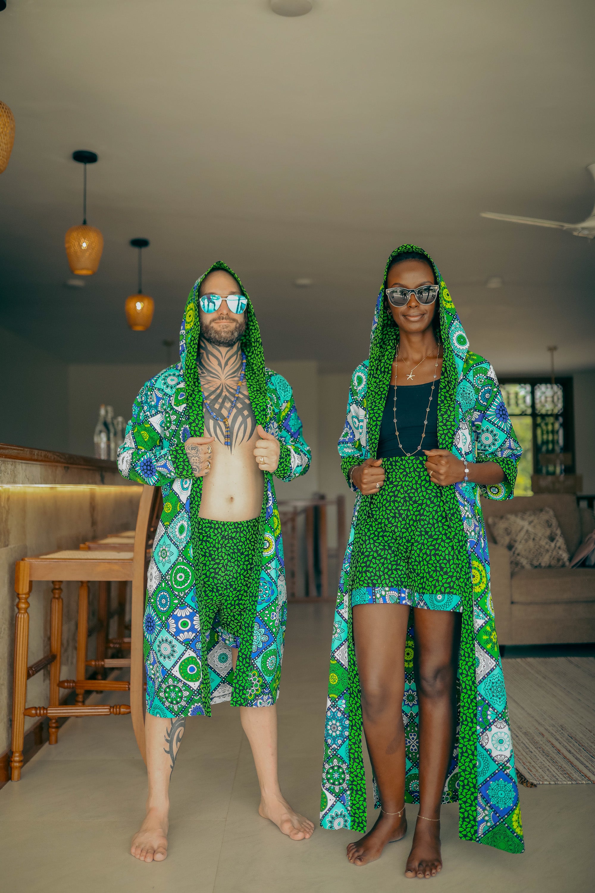 A stylish interracial couple wearing a matching set from zawadi hat fashion.
