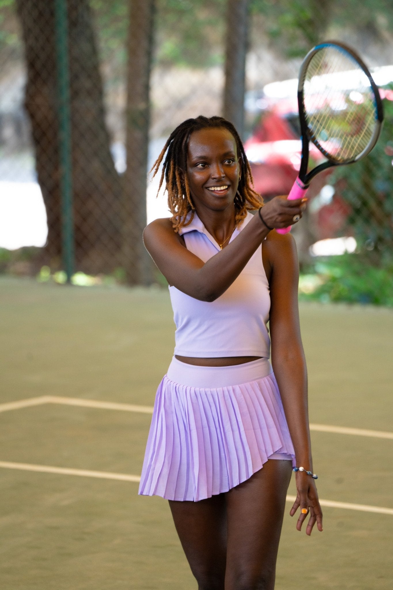 Poukies purple tennis set for couples; matching activewear top and bottoms, bold resort and gym look, Zawadi Hat Fashion