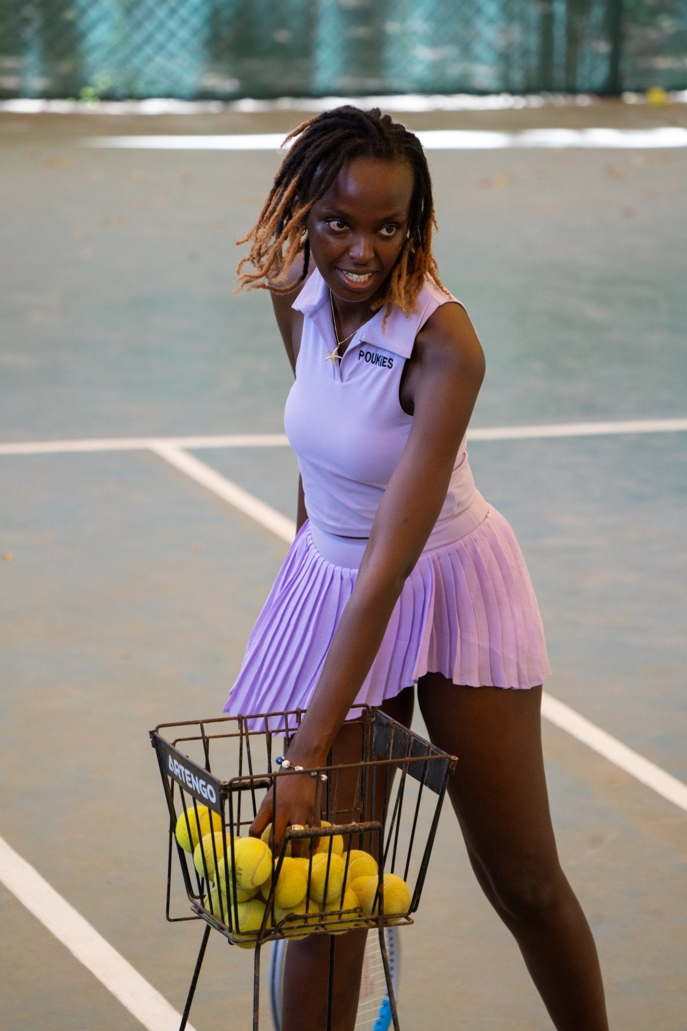 Poukies purple tennis set for couples; matching activewear top and bottoms, bold resort and gym look, Zawadi Hat Fashion