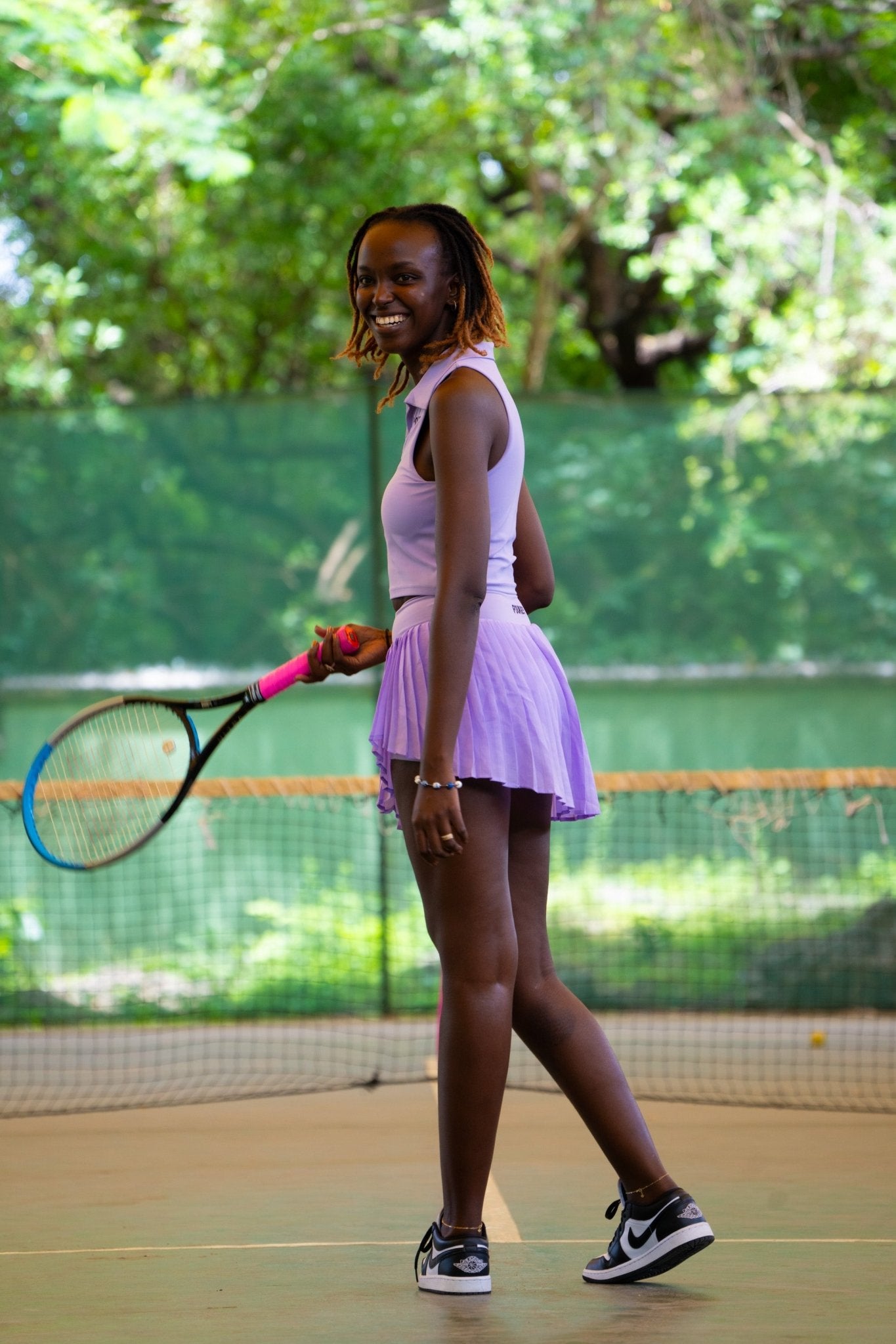 Poukies purple tennis set for couples; matching activewear top and bottoms, bold resort and gym look, Zawadi Hat Fashion