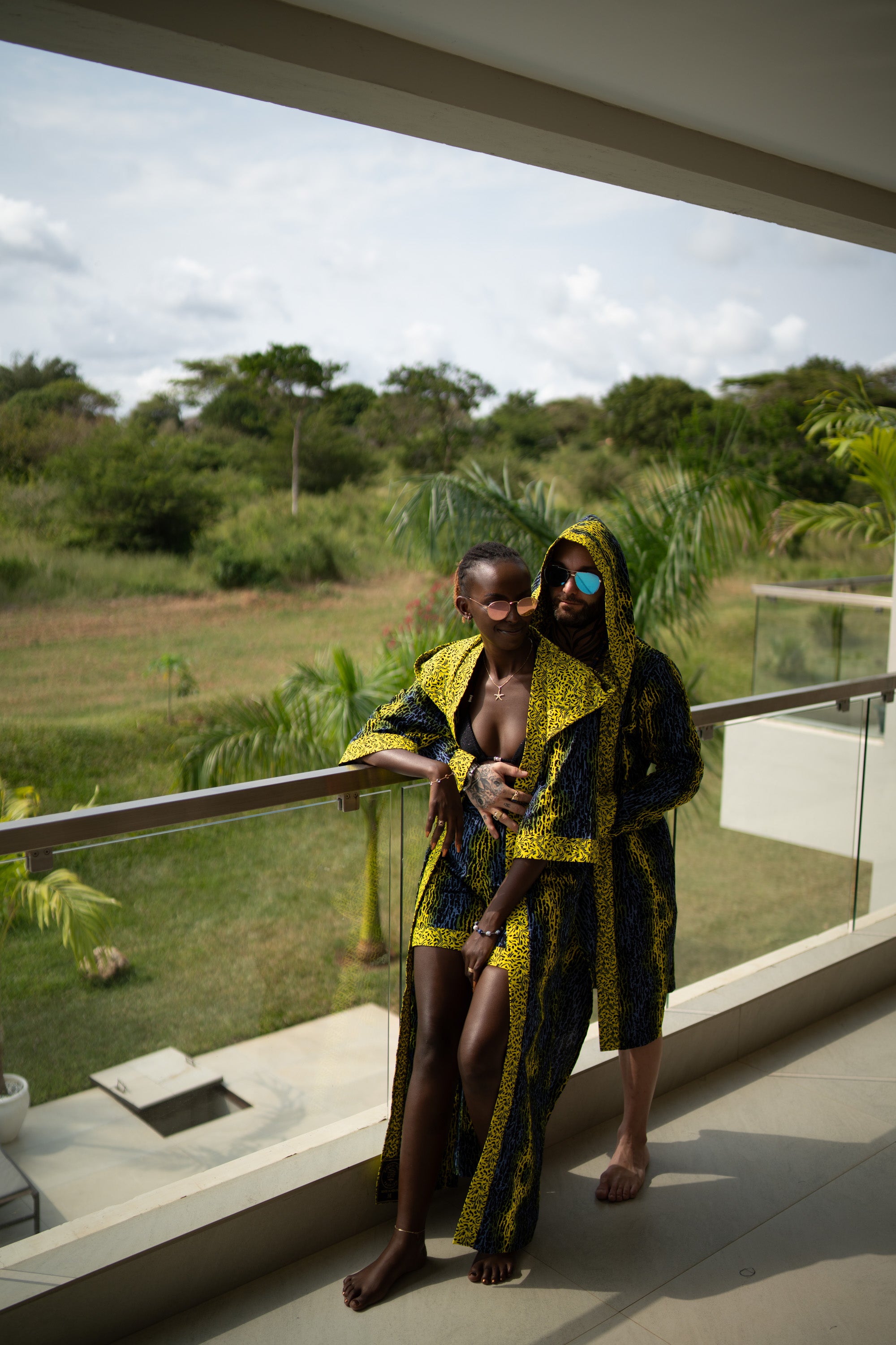 A couple styling Electric Safari African cover-up and shorts set in safari-inspired print – Zawadi Hat 