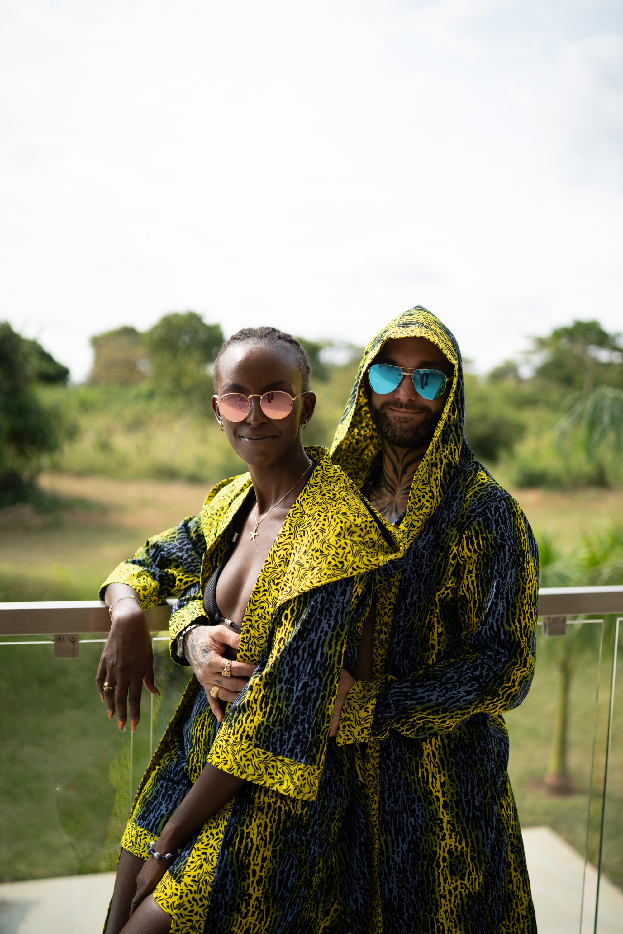 A couple styling Electric Safari African cover-up and shorts set in safari-inspired print – Zawadi Hat 