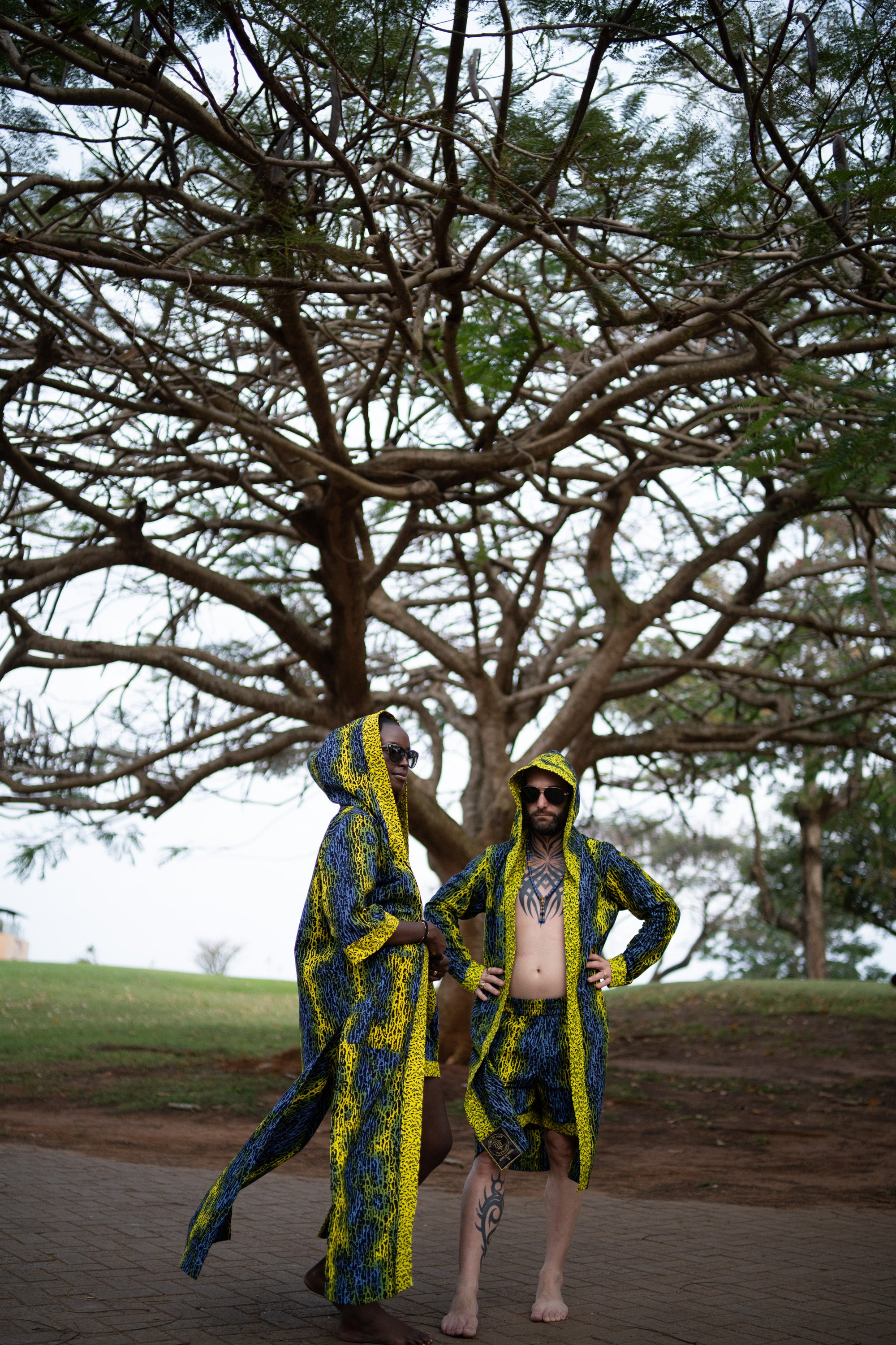 A couple styling Electric Safari African cover-up and shorts set in safari-inspired print – Zawadi Hat 