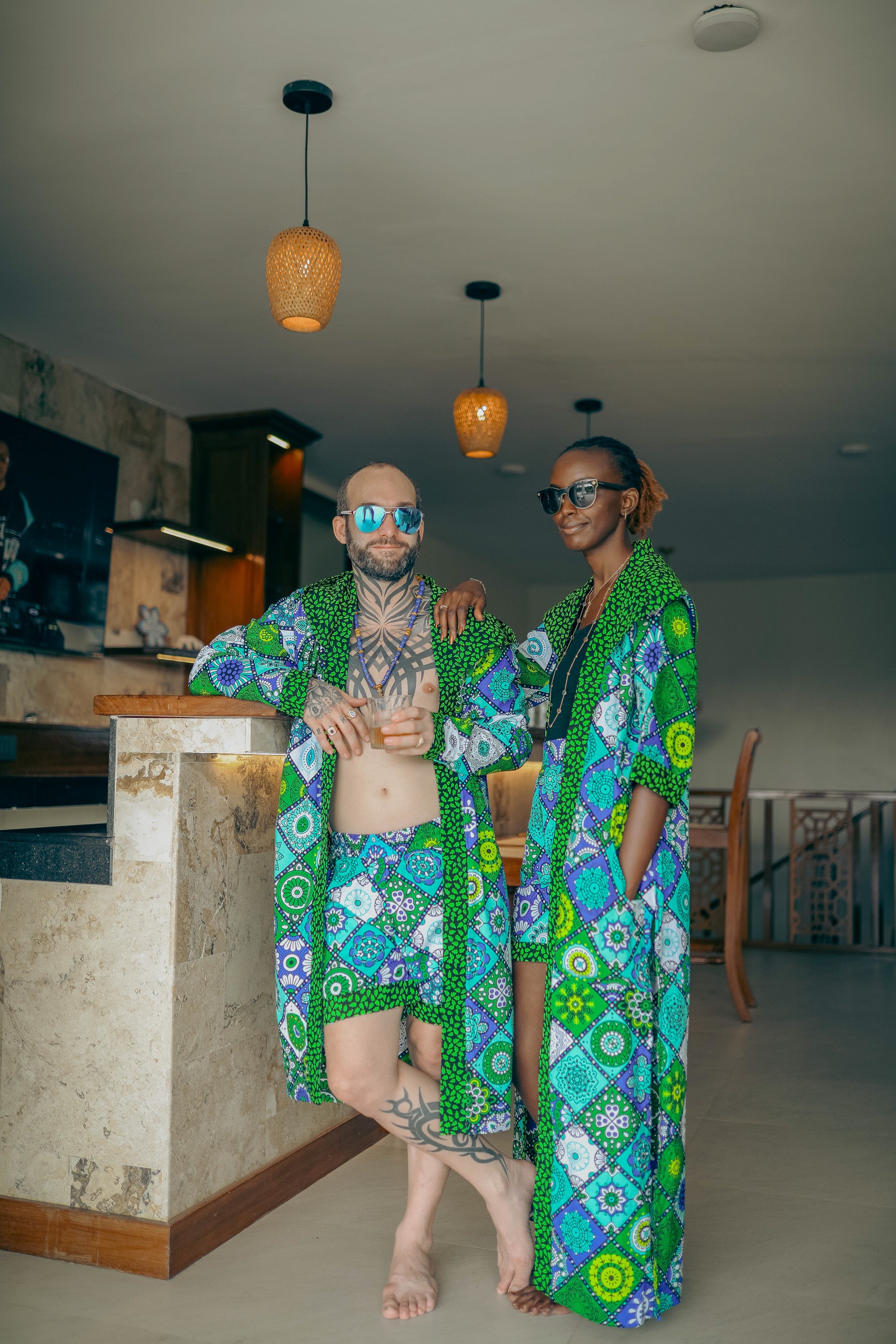 A couple in a bar wearing a matching set made from zawadi hat fashion