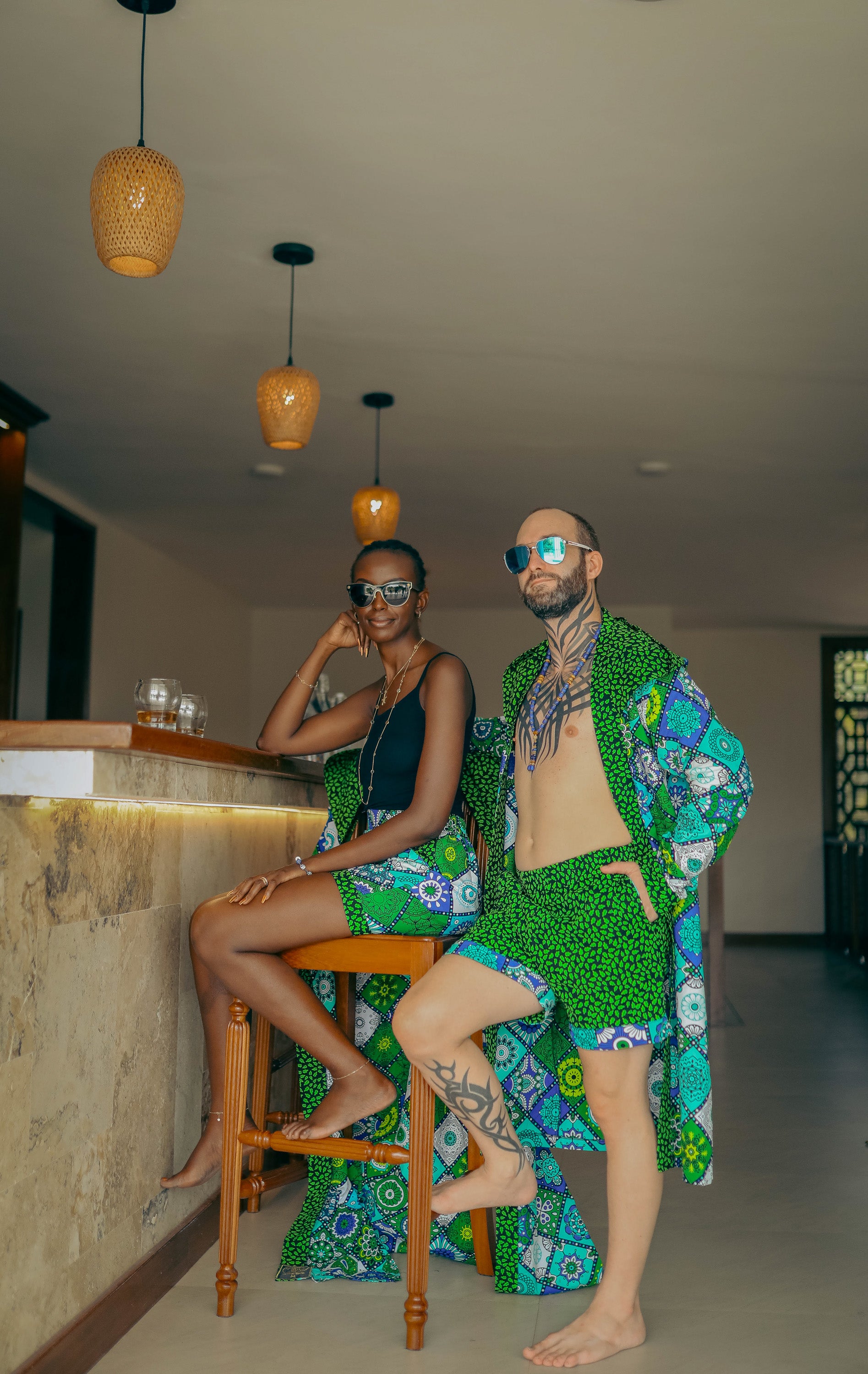 A couple in a bar wearing a matching set made from zawadi hat fashion