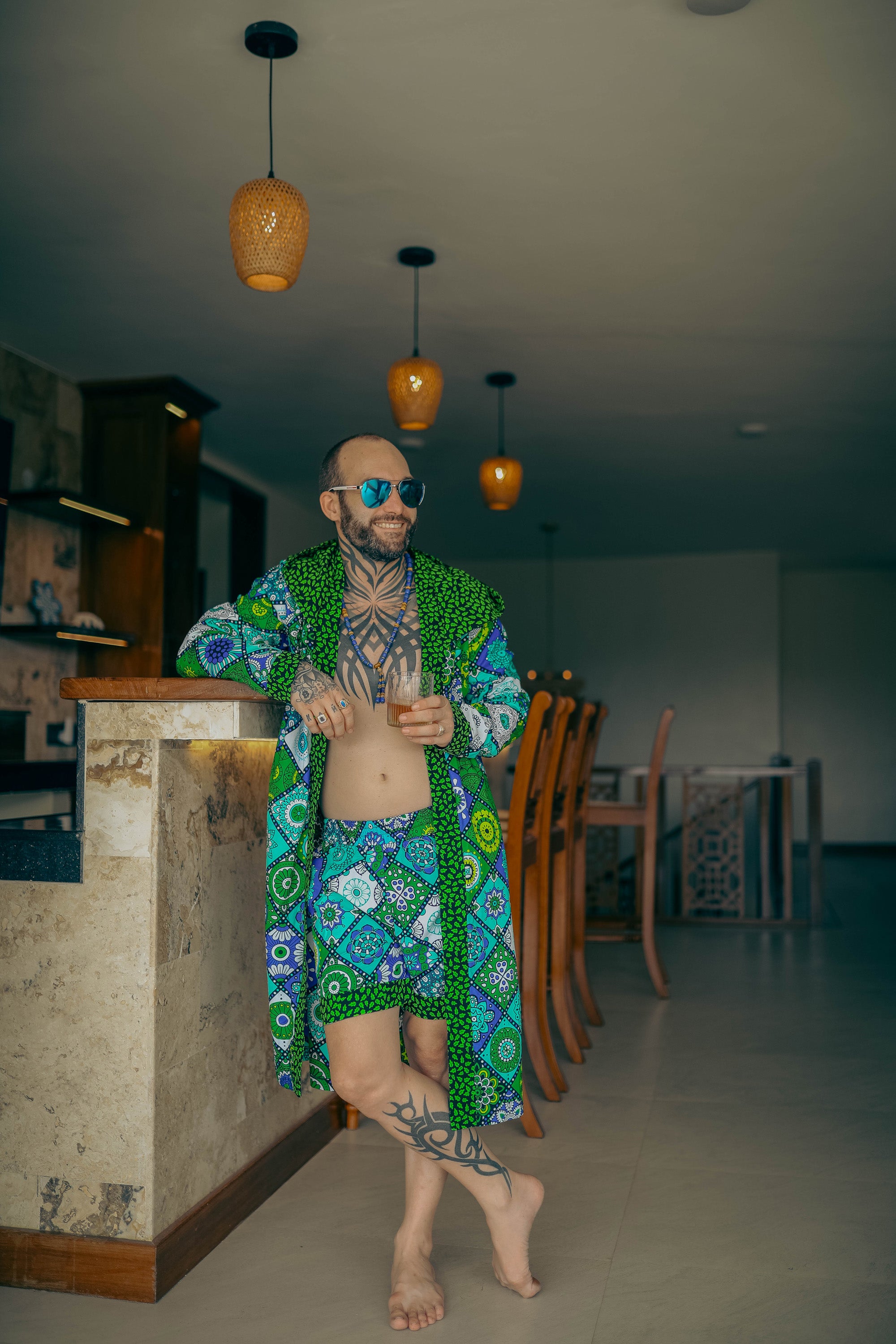 Man wearing Mandala Bloom African cover-up and shorts set with vibrant mandala print.