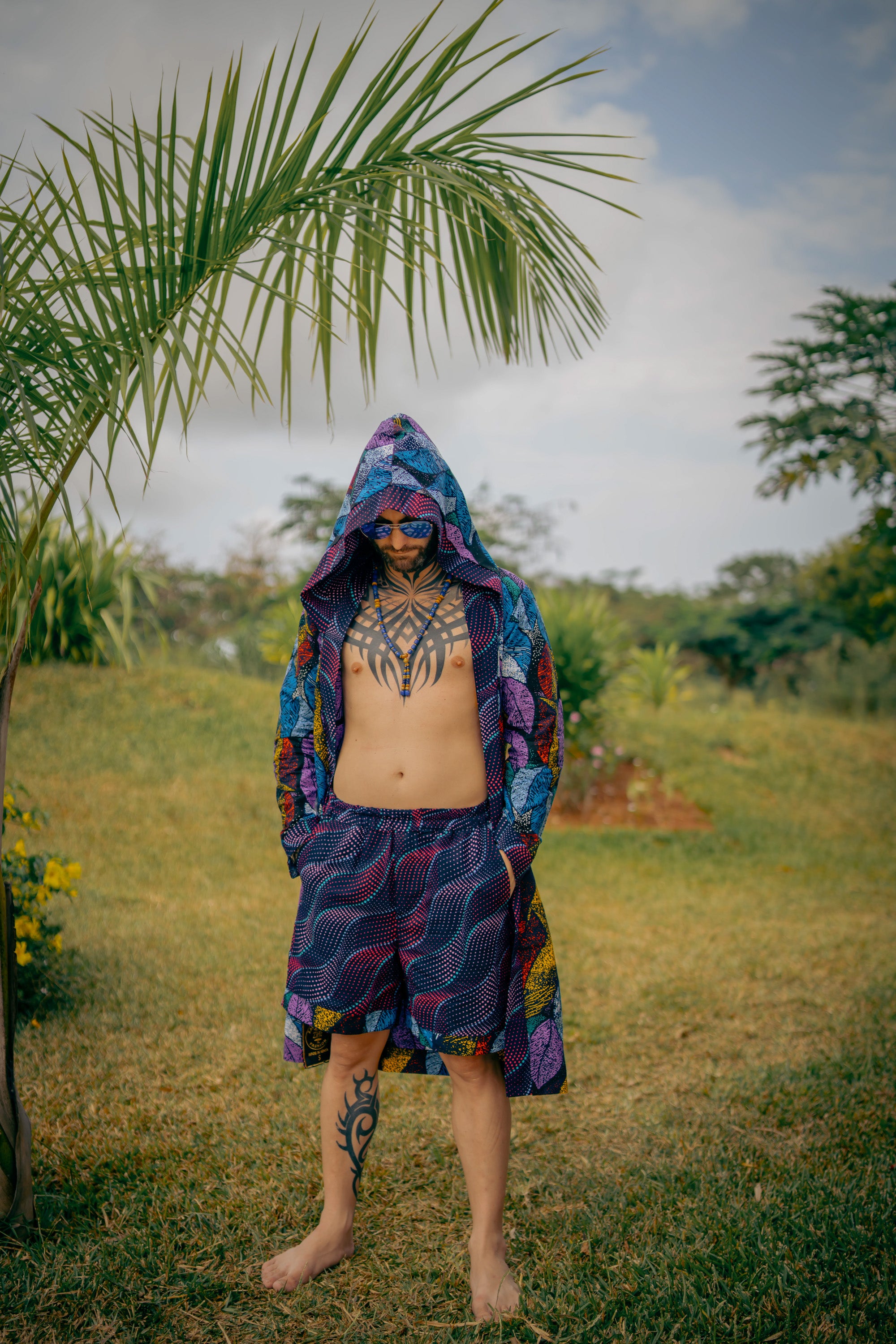 Man in Midnight Garden African cover-up and shorts with bold midnight floral design.
