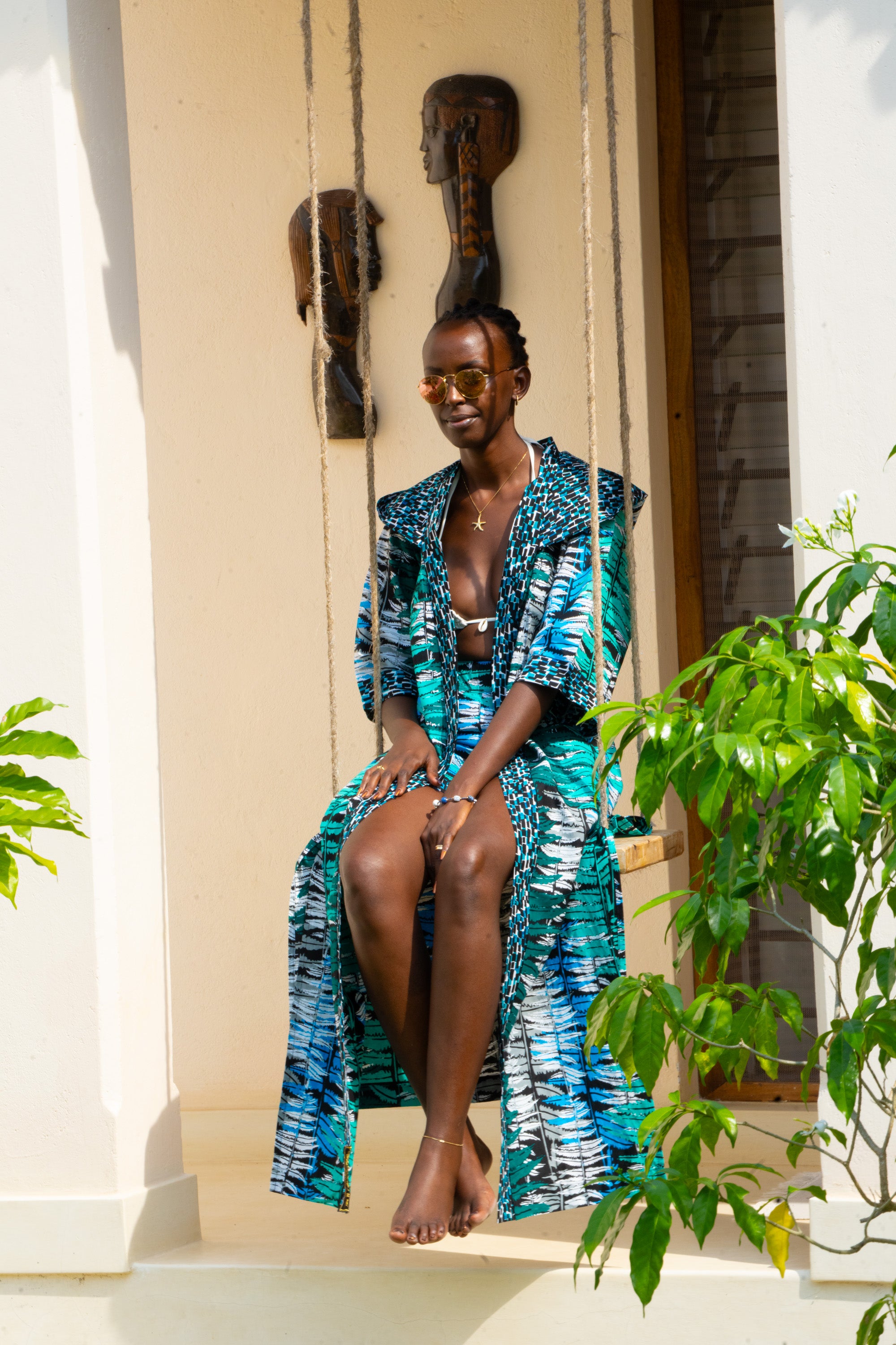 Ocean Teal African cover-up and shorts set in cool teal tones worn by woman.