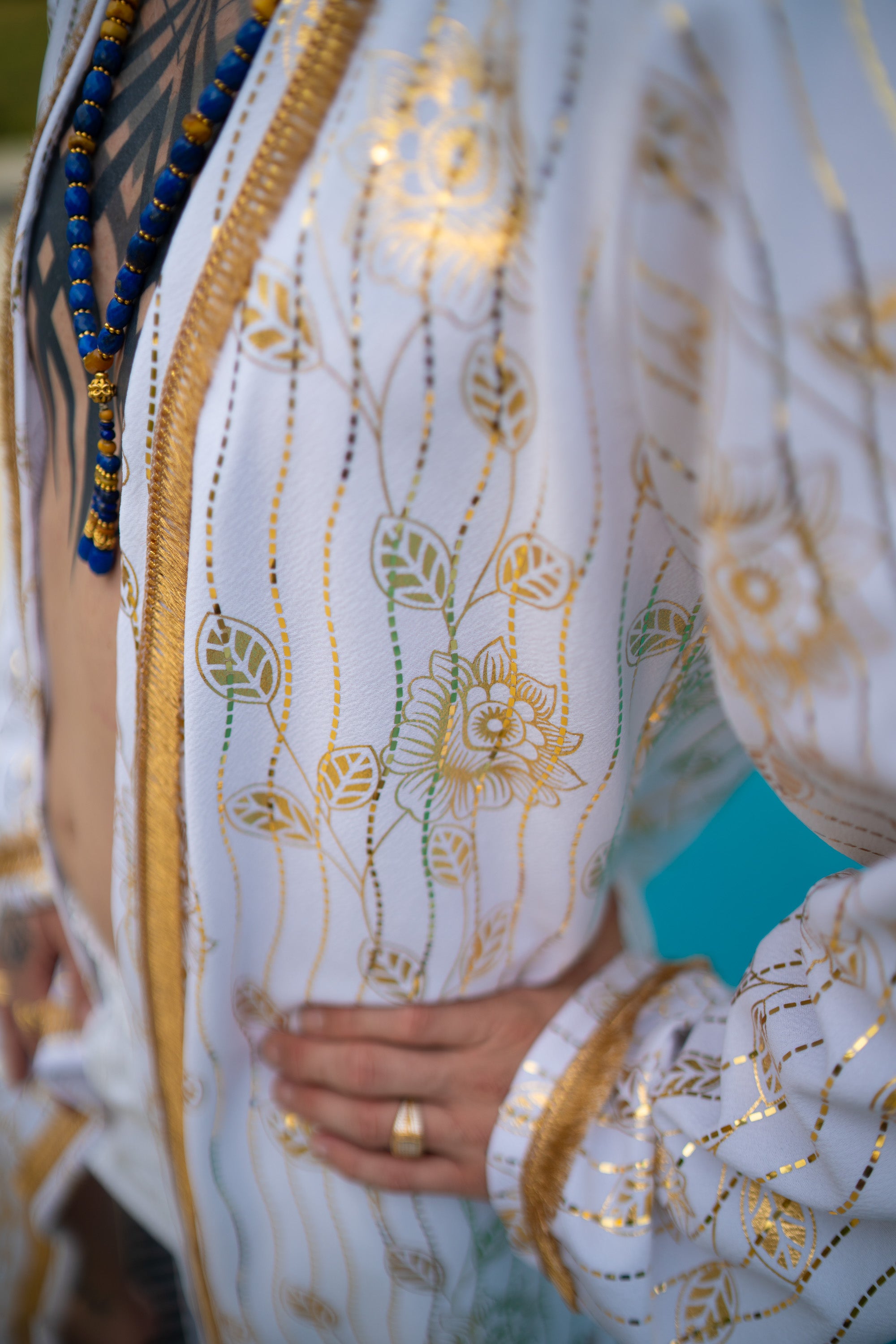 A man with White and Gold cover-up with golden accents.