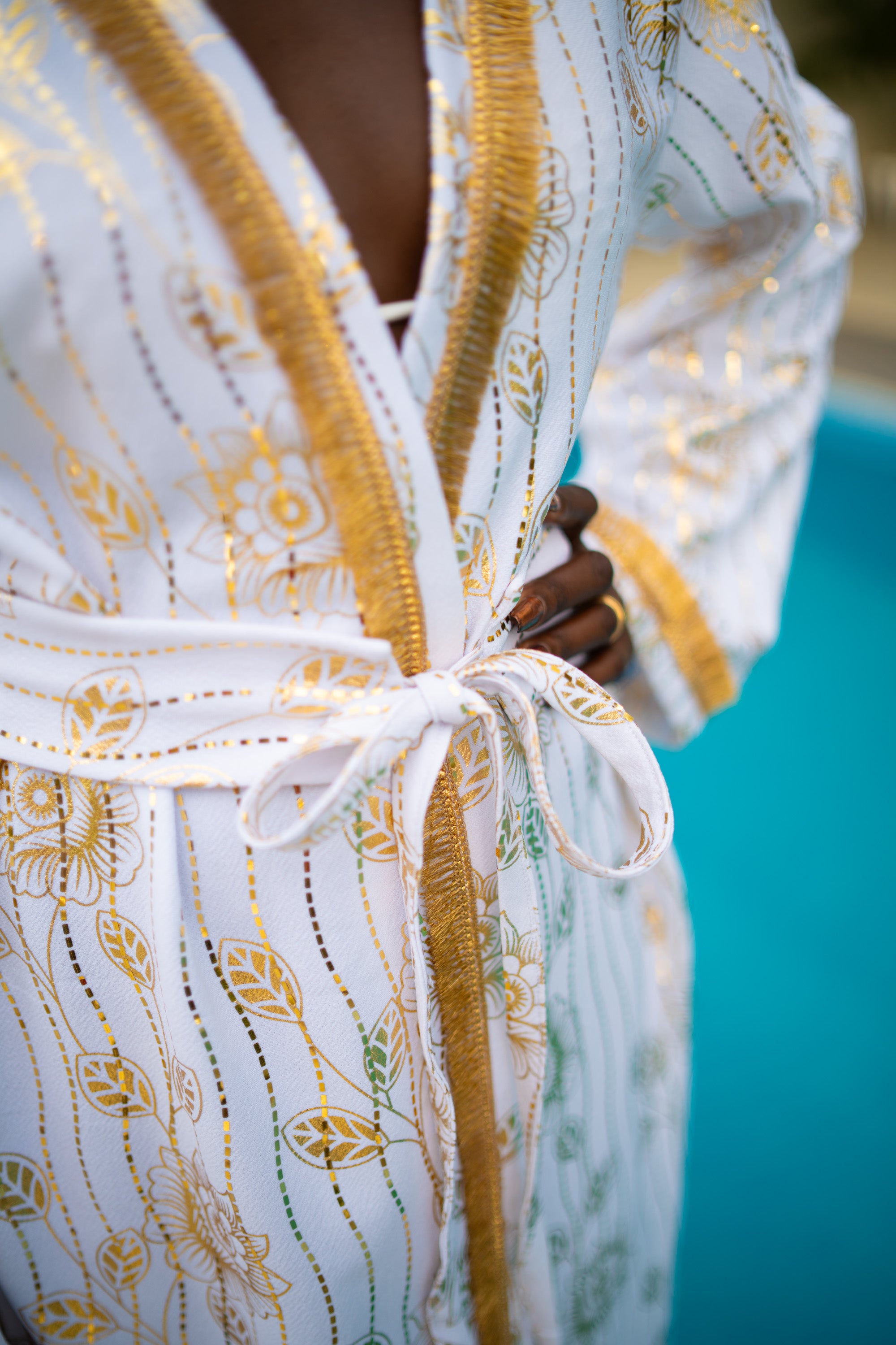 A woman with White and Gold cover-up with golden accents