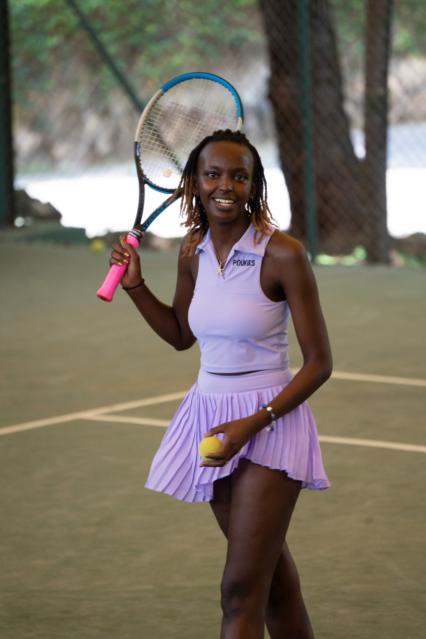 Poukies purple tennis set for couples; matching activewear top and bottoms, bold resort and gym look, Zawadi Hat Fashion