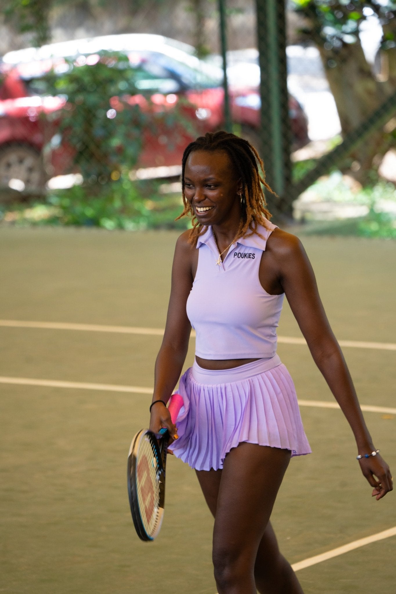 Poukies purple tennis set for couples; matching activewear top and bottoms, bold resort and gym look, Zawadi Hat Fashion