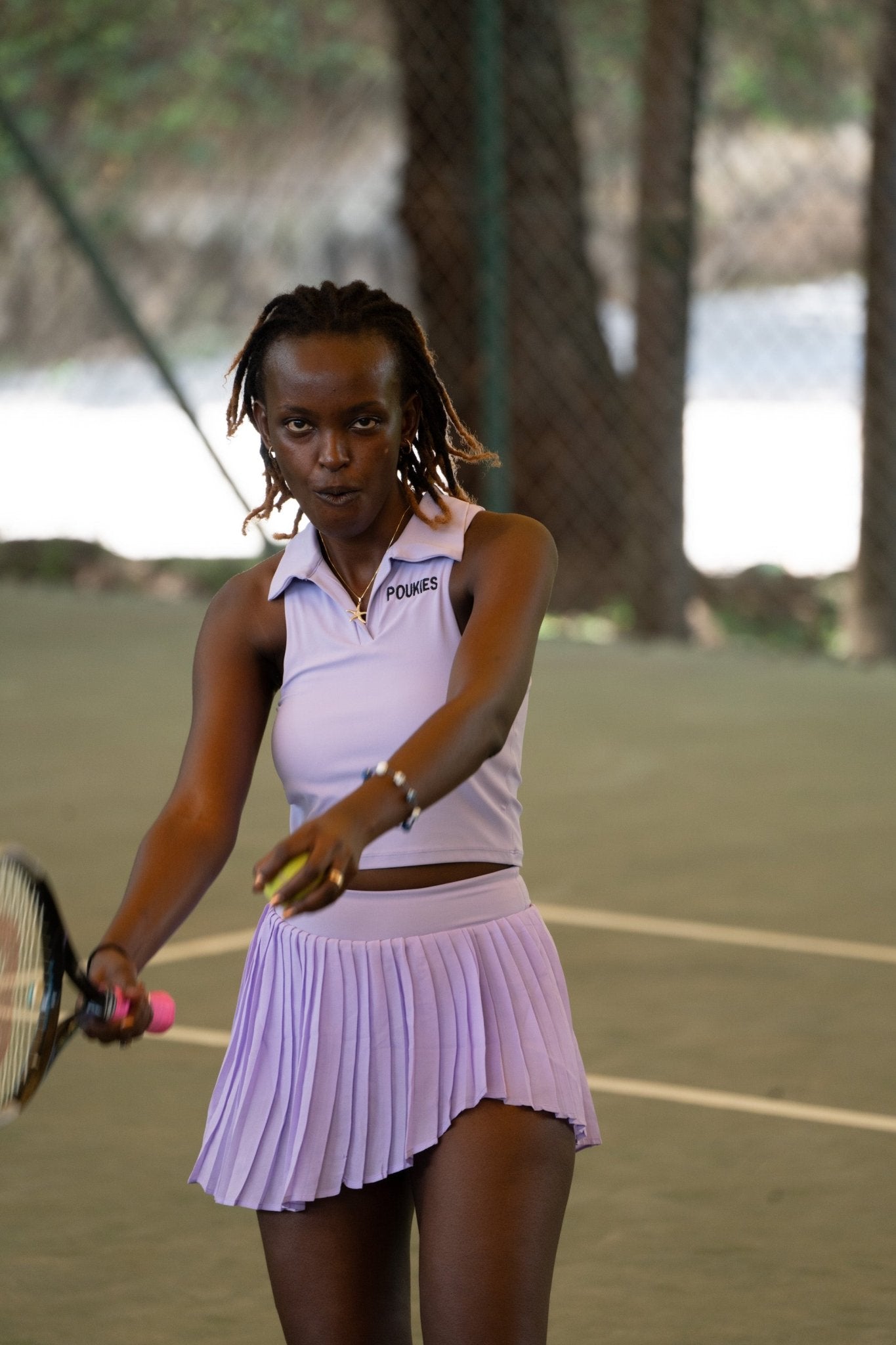 Poukies purple tennis set for couples; matching activewear top and bottoms, bold resort and gym look, Zawadi Hat Fashion