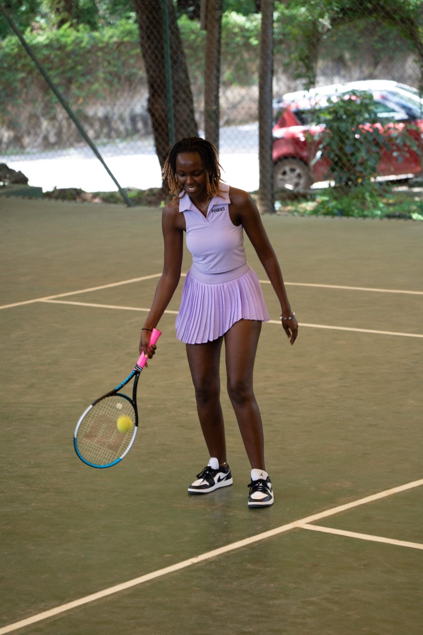 Poukies purple tennis set for couples; matching activewear top and bottoms, bold resort and gym look, Zawadi Hat Fashion