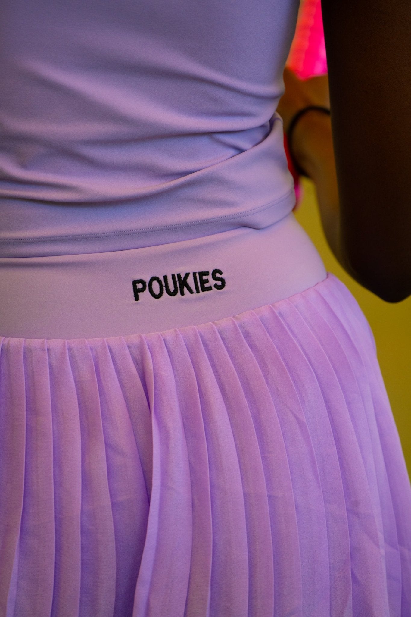 Poukies purple tennis set for couples; matching activewear top and bottoms, bold resort and gym look, Zawadi Hat Fashion