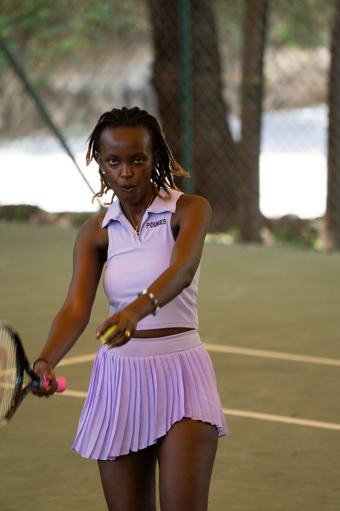 Poukies purple tennis set for couples; matching activewear top and bottoms, bold resort and gym look, Zawadi Hat Fashion