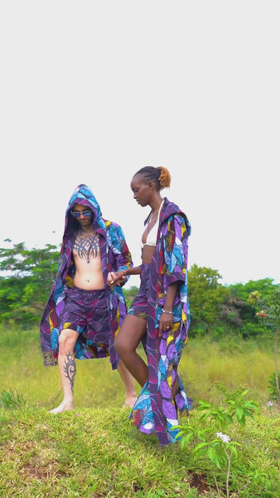 A video of a couple walking in the nature wearing matching set of african cotton cover up.